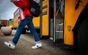 Student walking off of school bus.